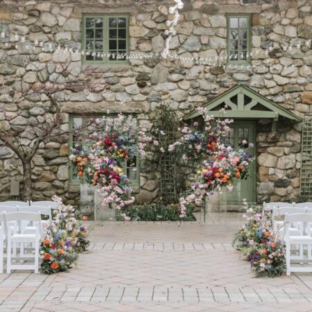 A Wedding Ceremony Trend We're Loving: Grounded Floral Arches